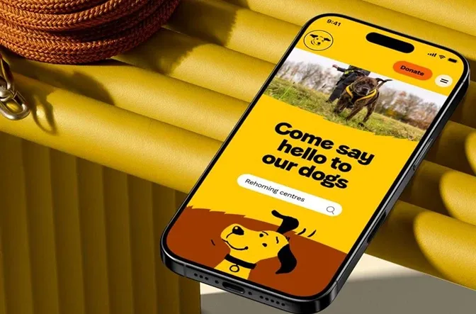 Dogs Trust promotional image with mobile phone