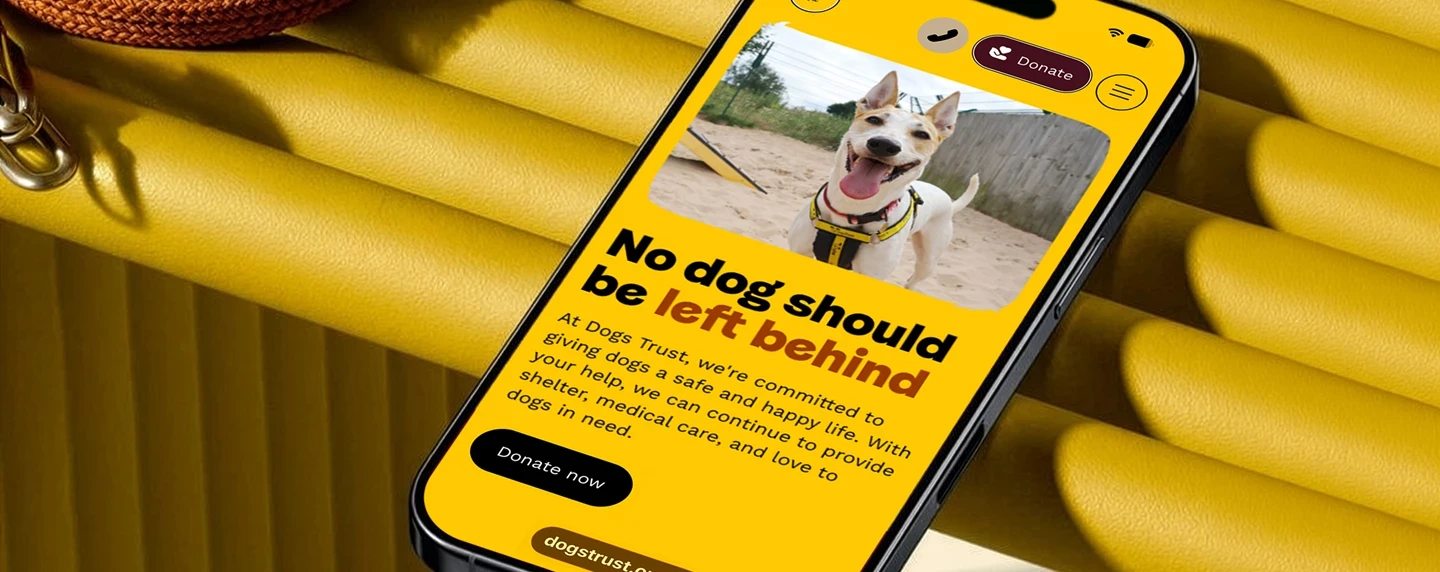 Dogs Trust promotional hero showing website on mobile phone