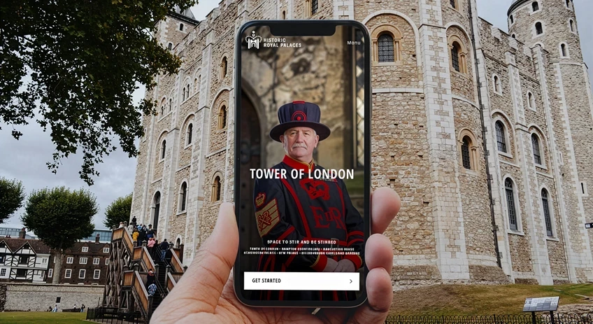 HRP HERO - promotional image of the app being used on mobile phone in front of tower