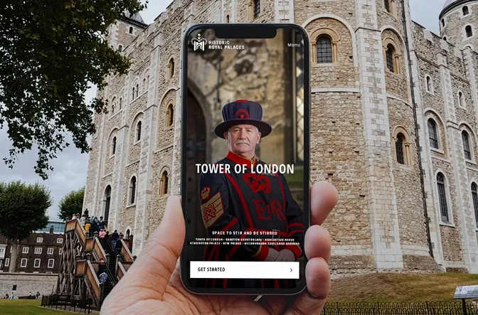 HRP HERO - promotional image of the app being used on mobile phone in front of tower