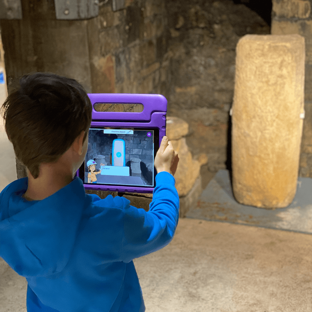 Boy using our alex the archeologist app