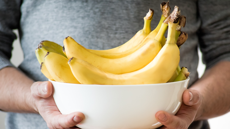 Someone holding up fruit.